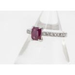 A ruby and diamond white 18ct gold dress ring, the mixed rectangular cut ruby in four claw setting