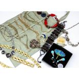 A large collection of costume jewellery including a black bead and read fringe necklace, various