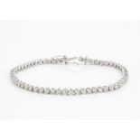 An 18ct white gold diamond tennis bracelet, brilliant cuts in claw setting with tongue and box