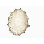 An early Victorian silver salver by DH CH, shaped rim with shells, engraved to well, on three