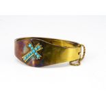 An Edwardian yellow metal and turquoise bangle, the ovoid hinged top with central decoration of