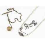 A cultured graduated string of pearls, two paste set bow brooches and a gilt metal fob chain