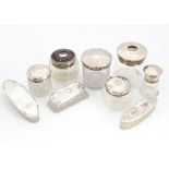 A group of nine Victorian and later glass and silver mounted dressing table items, including a