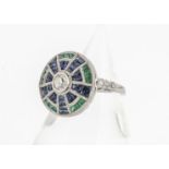 A platinum Art Deco style emerald, sapphire and diamond circular tablet ring, with old cut diamond