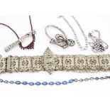 A collection of paste set costume jewellery, including a silver plated ornate and pierced embossed