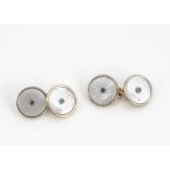 A pair of 18ct gold mother of pearl and sapphire cufflinks, centred with circular cut sapphires,