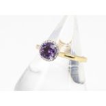 An amethyst and diamond dress ring, all in 9ct gold, the claw set amethyst surrounded by a bezel