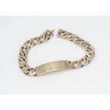 A 9ct gold identity bracelet, the flattened curb links with central curved rectangular plate,