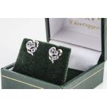 A pair of 9ct gold tanzanite and diamond stud earrings, in heart shaped settings, boxed