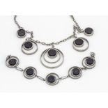 A Scandinavian style suite of costume jewels, comprising a necklace and bracelet with kinetic