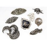 A collection of silver and white metal marcasite and paste brooches, including a double clip