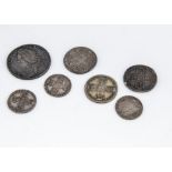 Seven George II silver coins, including a 1746 half crown, F, three shillings and three sixpences (