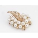 A continental yellow metal and cultured pearl brooch, of feather and pearl cluster design marked 14k