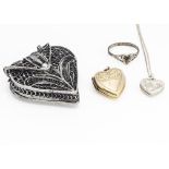 A collection of heart shaped jewellery, including a white metal filigree purse, a silver heart