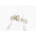 An 18ct gold fancy coloured diamond solitaire, the princess cut yellow in gold four claw raised