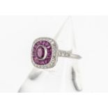 A ruby and diamond tablet dress ring, centred with an oval mixed cut ruby surrounded by a fan of