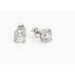 A pair of diamond stud earrings, the brilliant cut in four claw setting on a post back with