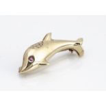 A contemporary continental 18ct gold diamond and ruby dolphin brooch, 3.4cm long, 4.5g