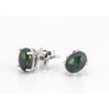 A pair of black cabochon opal claw set ear studs set in silver