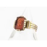 An Edwardian gentleman's yellow metal signet ring, set with carnelian intaglio of Roman gentleman