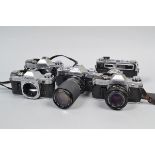 Japanese Cameras, comprising a chrome Canon AE-1 with FD 50mm f/1.8 lens, two chrome Canon AE-1