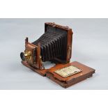 A Half Plate Mahogany and Brass Field Camera condition F, with focusing screen, a Beck Symmetrical