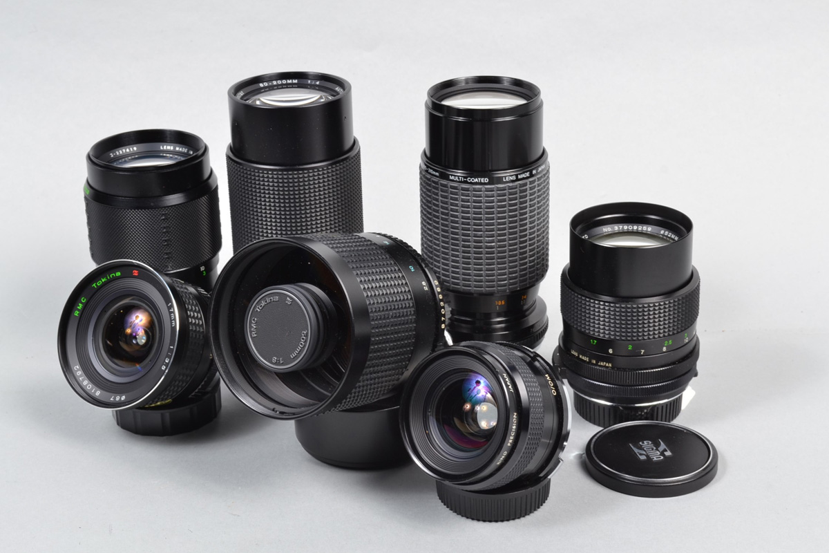 A Group of OM mount Lenses, a Tokina 17mm f/3.5 lens, barrel G, elements G, a Kiron 28mm f/2.8 lens,
