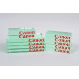 Canon Retail Display Stands, transparent, green tinged, solid acrylic blocks with red Canon logo