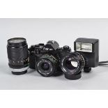 A Canon A-1 SLR Camera with FD Lenses, serial no 135866, body G, shutter working with "squeak",