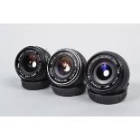 Three Olympus Auto W Wide Angle Lenses, OM mount, a Zuiko 24mm f/2.8 lens, barrel G, elements G,