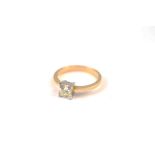 A diamond solitaire ring, the princess cut in white four claw setting on a tapered 18ct gold