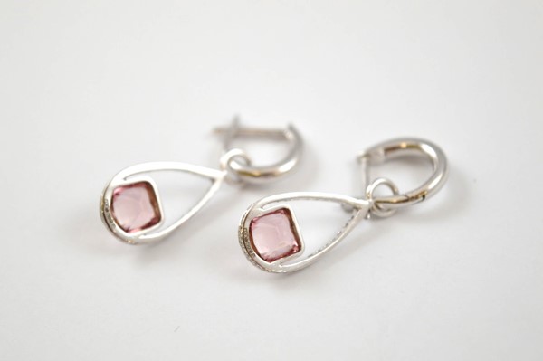 A pair of 9ct gold pink tourmaline and diamond drop earrings, the pear shaped drops with cushion cut