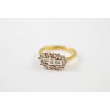A diamond dress ring, of ovoid shape centred with three baguette cuts surrounded by a bezel of