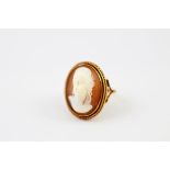 A shell cameo 9ct gold mounted ring, carved with the portrait of a female within a double rope twist