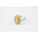 A heliodor and diamond dress ring, the mixed pear cut central golden beryl in five claw setting