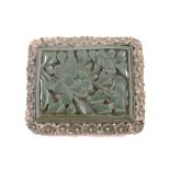 A Chinese and cinnabar lacquer clip, the green floral carved panel within a white metal mount marked