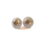 A pair of certificated 18ct gold diamond stud earrings, set with two brilliant cut fancy brown