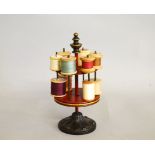 A 19th Century tole ware and cast iron cylindrical cotton reel stand, of two tier section with red