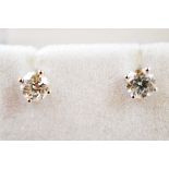 A pair of diamond ear studs, with post backs, brilliant cuts in four claw settings, total diamond