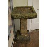 A reconstituted stone square plinthed bird bath, with tapered stem and shallow bath, 83cm high x