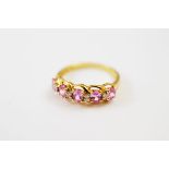 A contemporary 9ct gold pink sapphire and diamond dress ring, the mixed oval cut sapphires