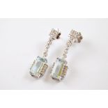A pair of Art Deco style aquamarine and diamond drop earrings, all in white metal, the rectangular