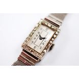 An Art Deco 18ct gold and diamond dress watch, of rectangular form with guilloche enamel face,
