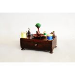 A 19th Century rosewood Cotton Reel stand of plinth shape with freeze drawer on bun feet with turned