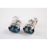 A pair of topaz oval mixed cut ear studs, set in silver, London blue variety