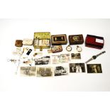 A mixed lot of collectables, including cigarette cards, two Smiths pocket watches, tins, photographs