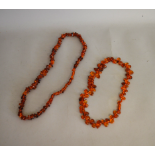 Two strings of amber beads, both rough translucent Baltic amber types with screw clasps, 31cm