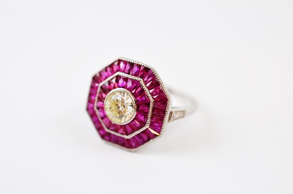 An Art Deco style ruby and diamond octagonal dress ring, with old cut diamond surrounded by two rows