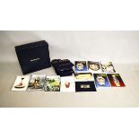 A collection of Moorcroft pottery catalogues and journals, price guides, bags and a lidded Moorcroft