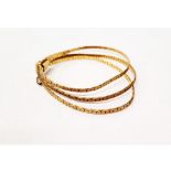 A three stand flattened curb link 9ct gold bracelet, with tongue and box clasp with safety clasp,